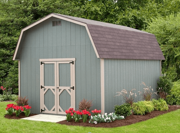 A green barn-style shed with a gambrel roof and double doors