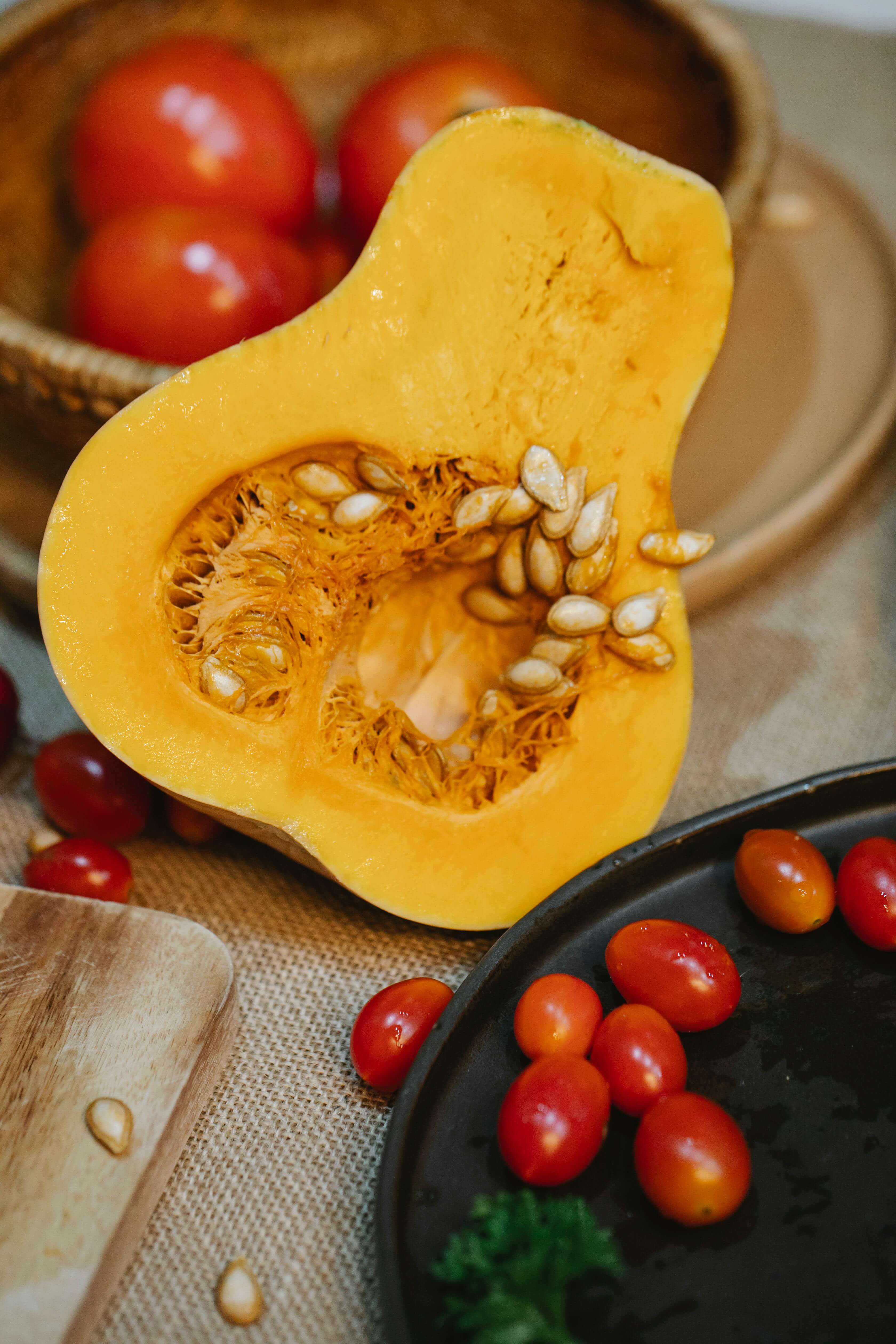 Fresh pumpkin seeds and cherry tomatoes, rich in zinc and lycopene for shrinking enlarged prostate naturally.